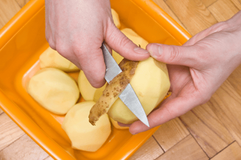 Peeling potato.