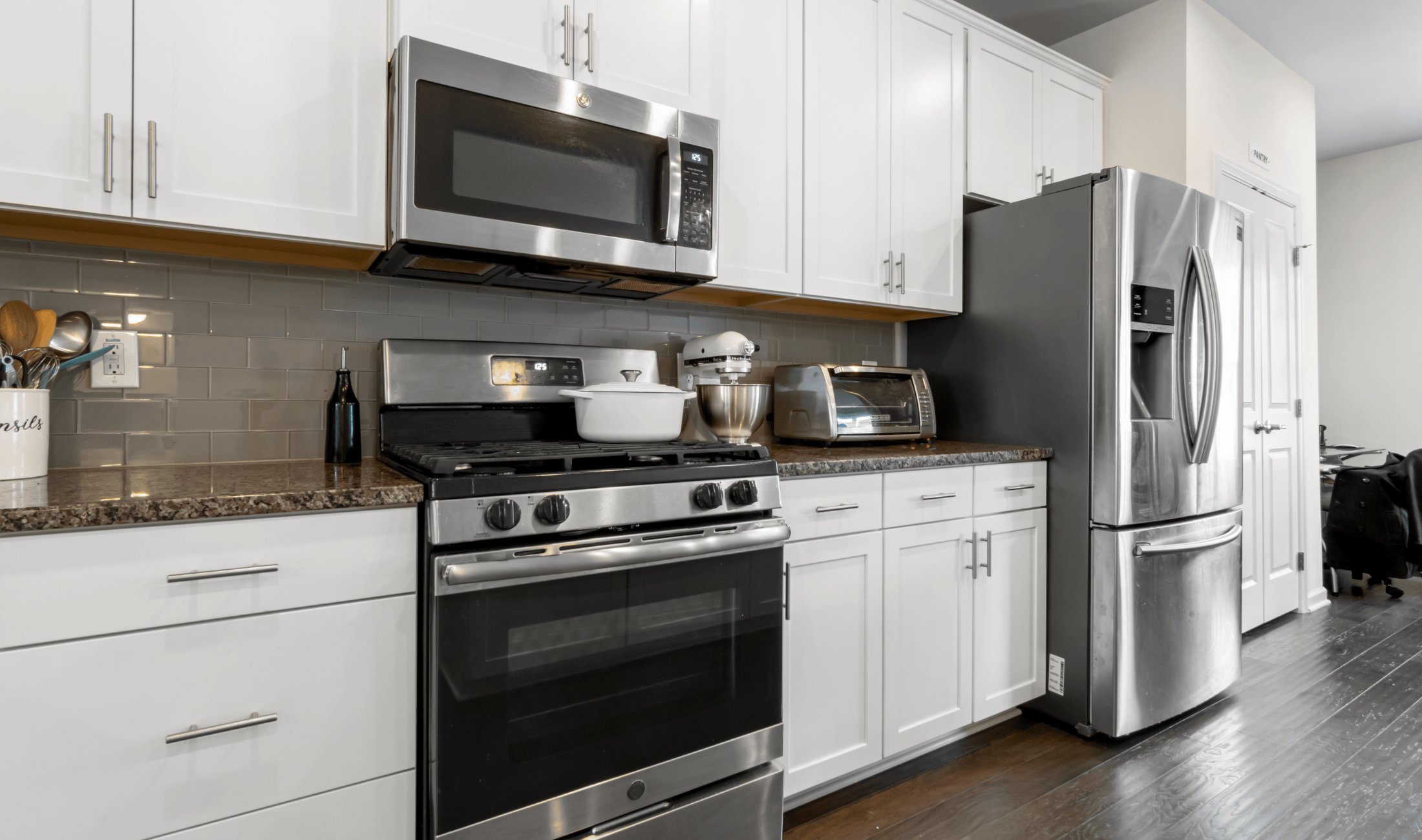 A modern kitchen, stove and kitchen in view.