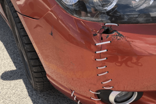 Car bumper held together with zip ties.
